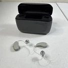 Resound Gn Model C-1 Hearing Aids (l+r) & Charging Station (read). Fixed Price $100.00.